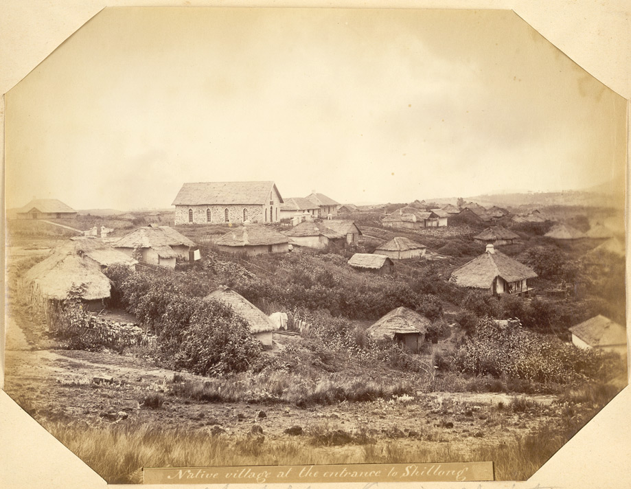 "Native village at the entrance to Shillong. Chapel for Kasia Christians" | View of a village scattered across a hillside with a chapel at the top photographed by Oscar Jean Baptiste Mallitte in the 1860s.