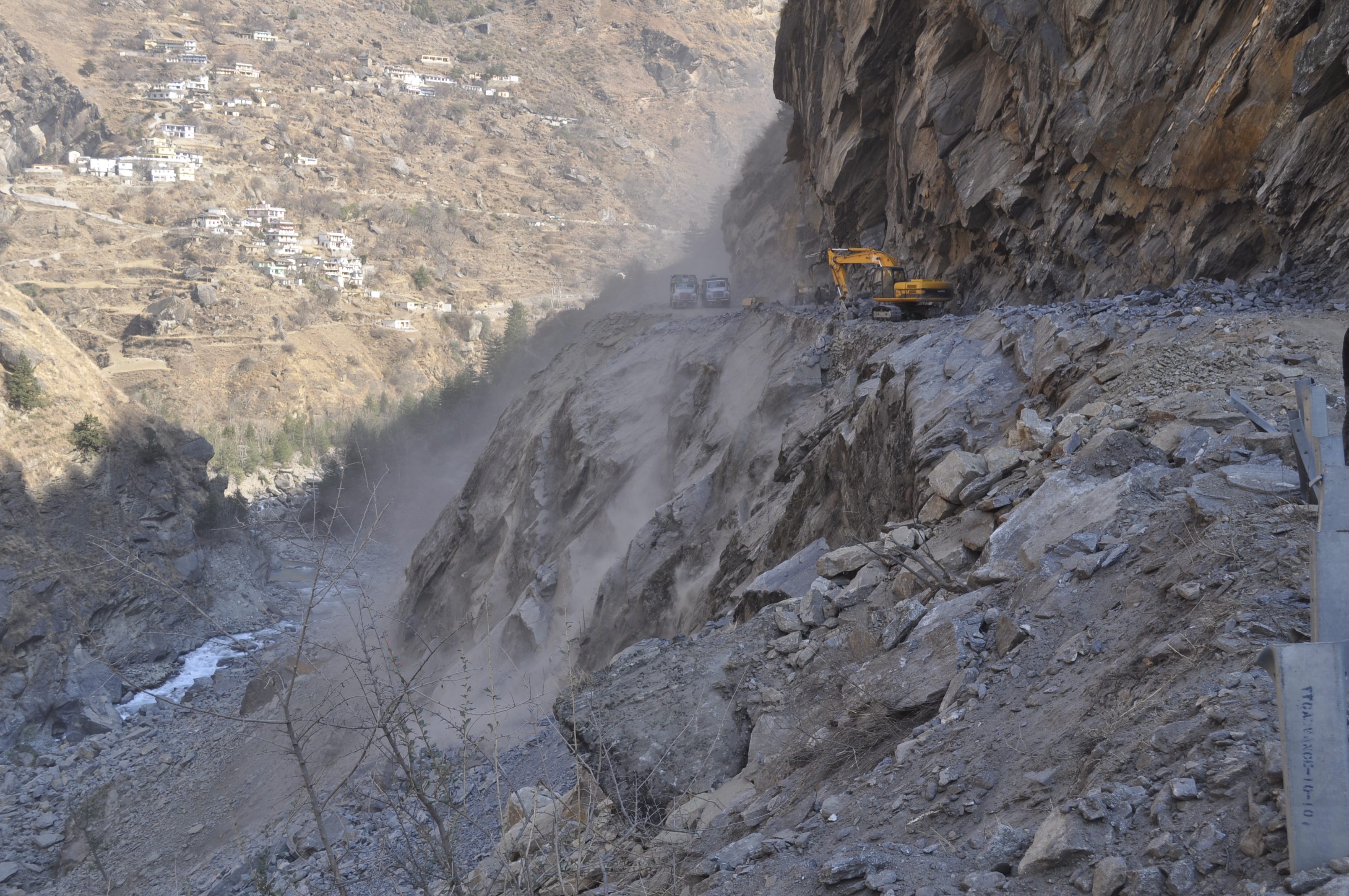 Pushing Debris down the slope on the banks of Dhauli Ganga -- On the way to Raini village