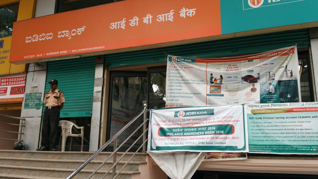 IDBI Bank. The ATM is behind the guard on the left, shutters half down.