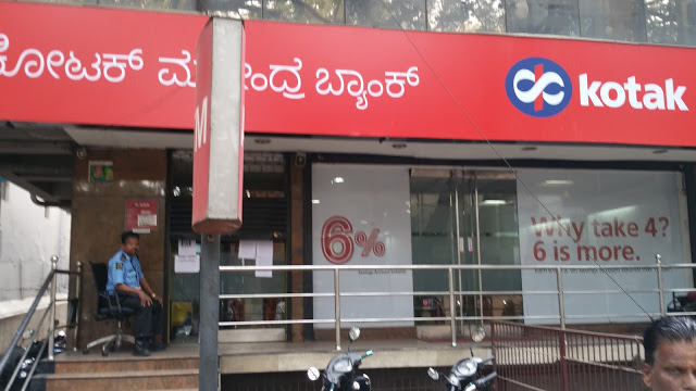 Fourth Kotak ATM, attached to a branch. A guard sits in front of a cashless machine.