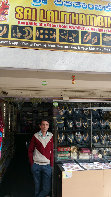 The owner of Sri Lalithambike, posing in front of his shop